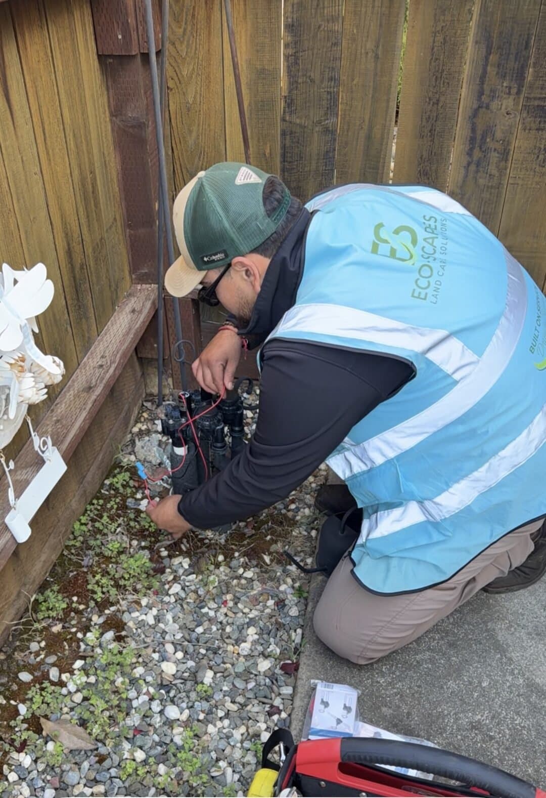 Eco-Scapes technician repairing irrigation valve wiring at a Benicia CA residence