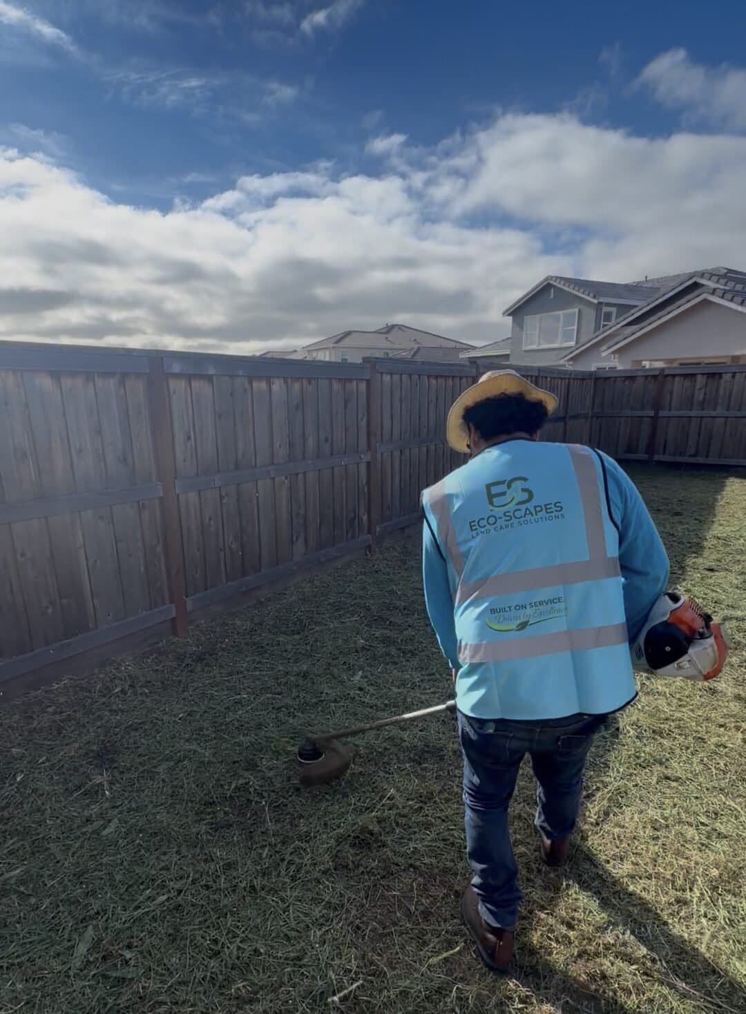 String trimming edges after a backyard lawn mow in Vacaville CA