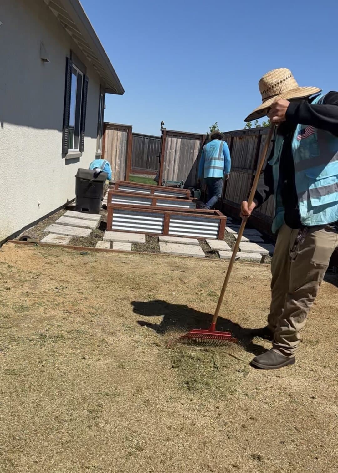 Eco-Scapes crew member raking grass clippings during a yard cleanup in American Canyon CA